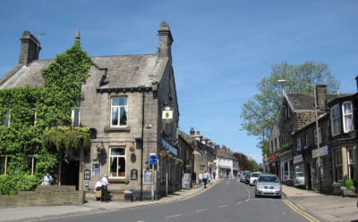 A snapshot of the road and shops on Town Street in Horsforth, Leeds, West Yorkshire.